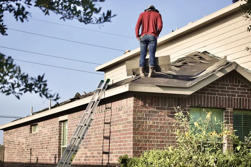 Professional roofer working on a residential roof in Laurel Beach